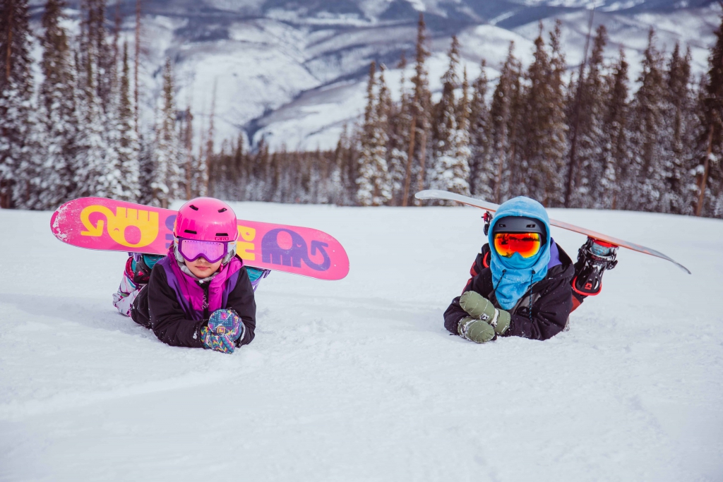 Two kids learn to snowboard