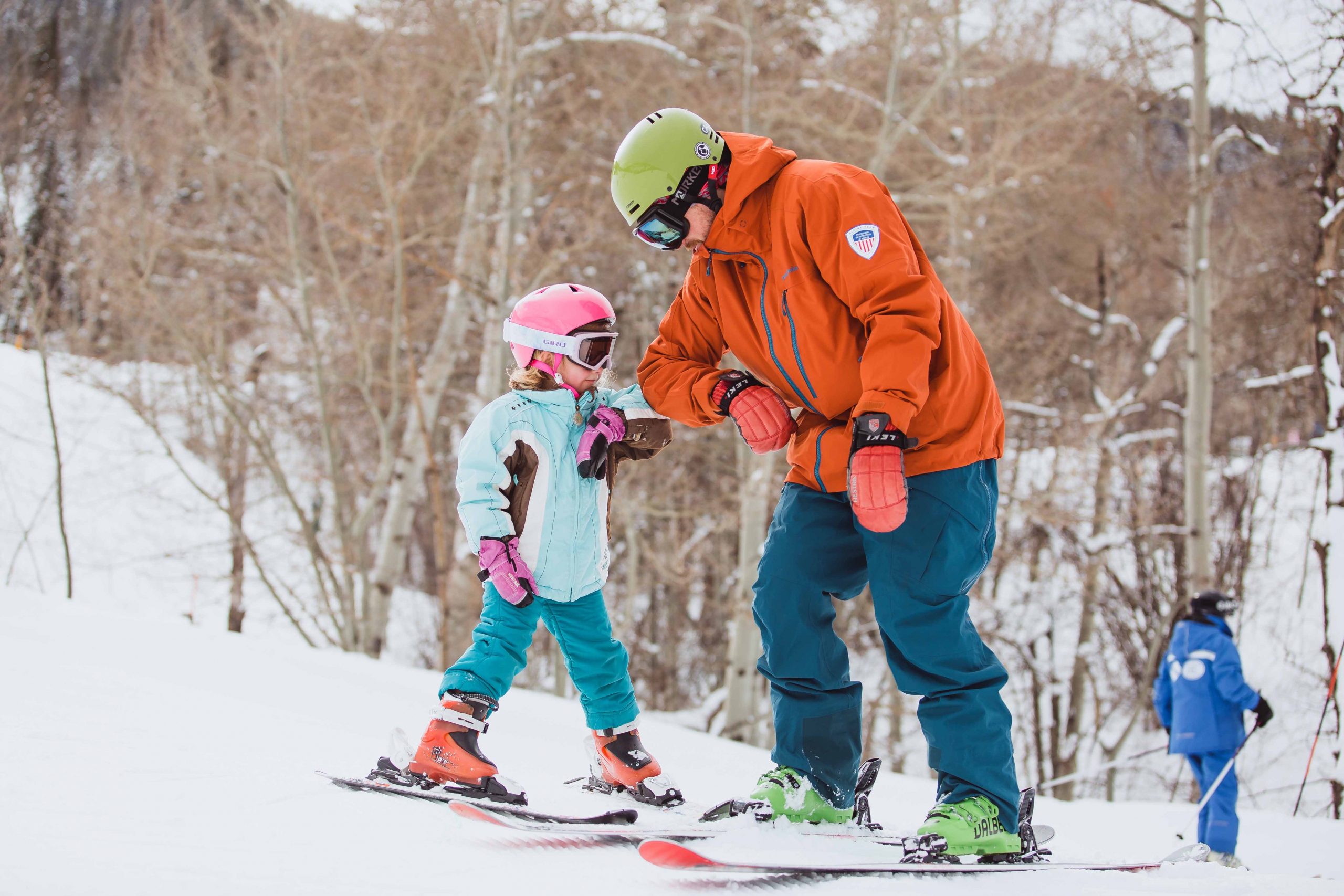 A girl and her ski instructor elbow bump