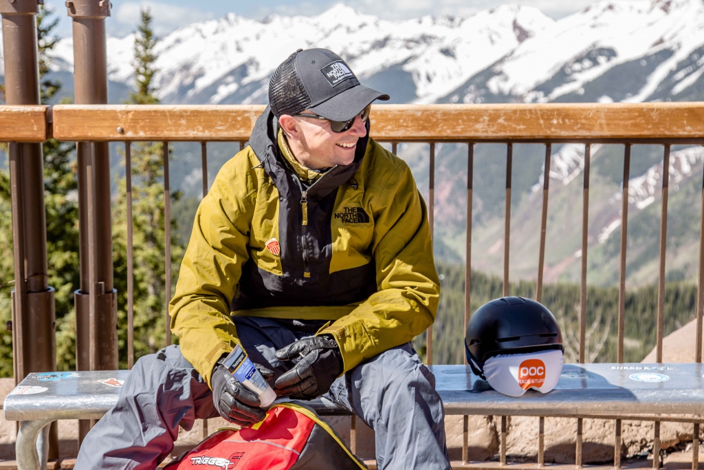 A skier applies sunscreen to get ready for the day skiing